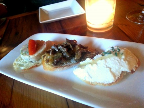 Assorted crostini: shrimp and sausage, gizzard and onion, ricotta and honey.
